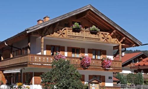 a large building with potted plants on the balcony at Ferienwohnung Alpenwelt in Mittenwald