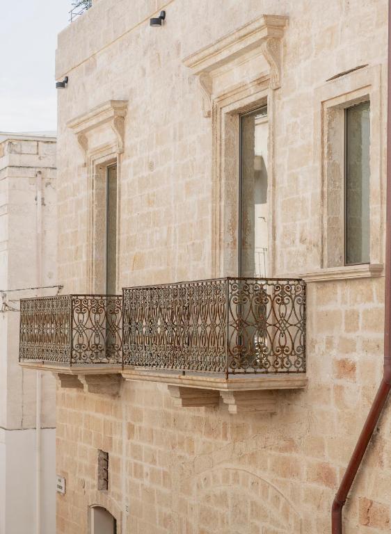 a balcony on the side of a building at Palazzo Cerere Boutique Hotel in Polignano a Mare
