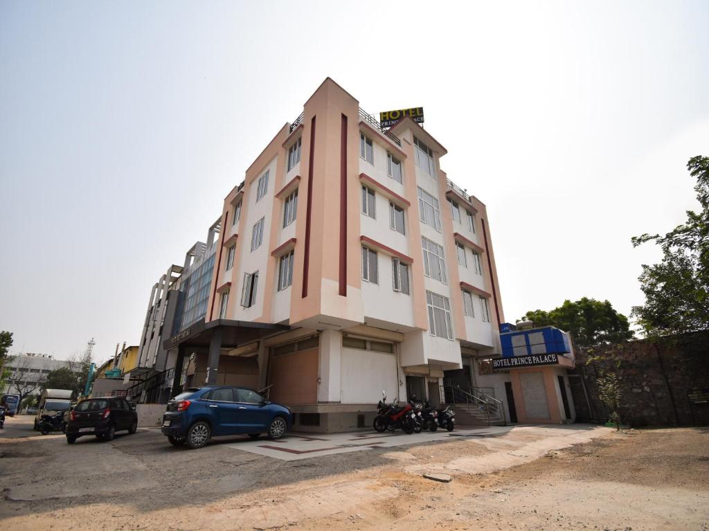 a building with cars parked in front of it at Hotel Grand Eagle Group in Jaipur