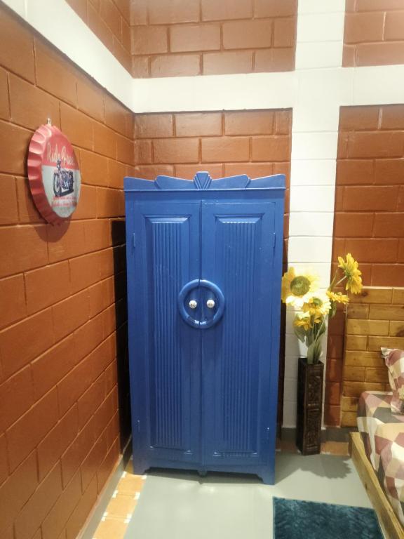 a blue out door in a brick wall at Amaiti pool villa in Bangalore