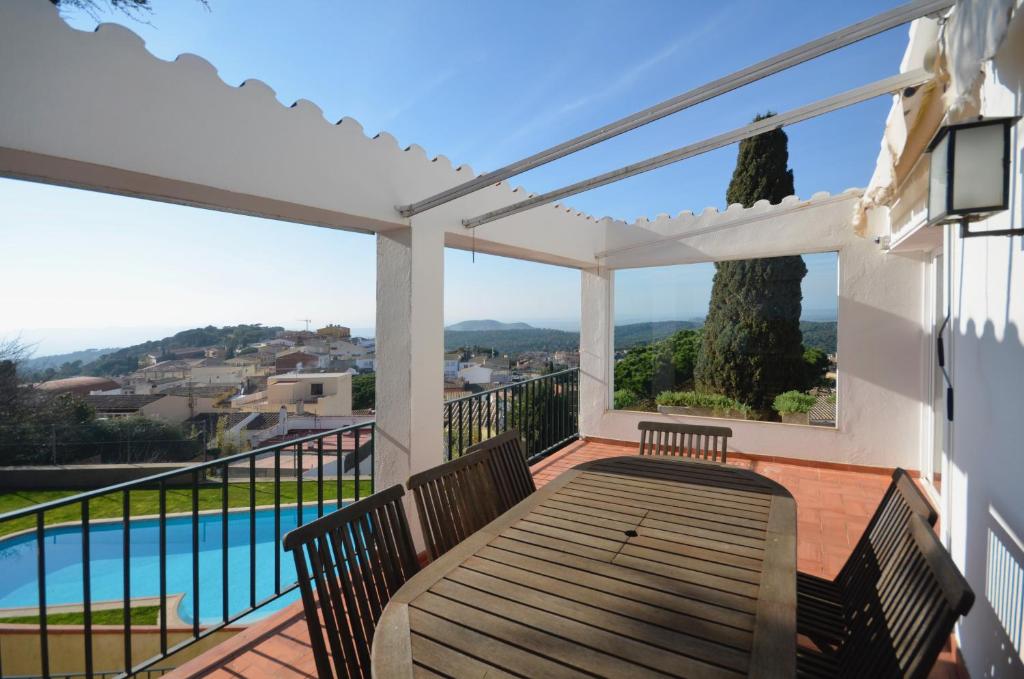 a patio with a table and chairs on a balcony at Quatre vents Ref 163 in Begur