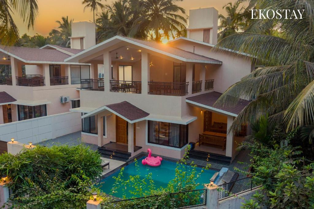 an aerial view of a house with a swimming pool at EKOSTAY - Mercury Villa in Alibaug