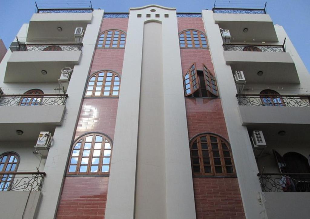 a tall building with a clock tower on it at Fayrouz Apartmernts in Luxor