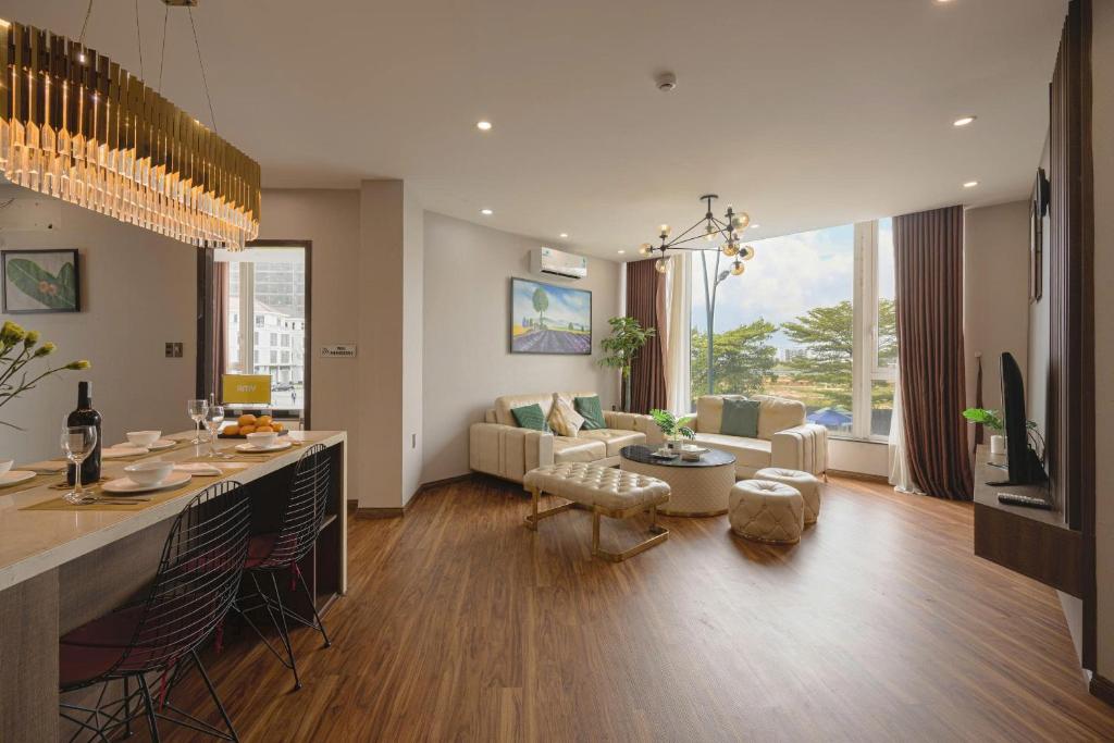 a kitchen and living room with a couch and a table at Amy Apartment Hue in Hue