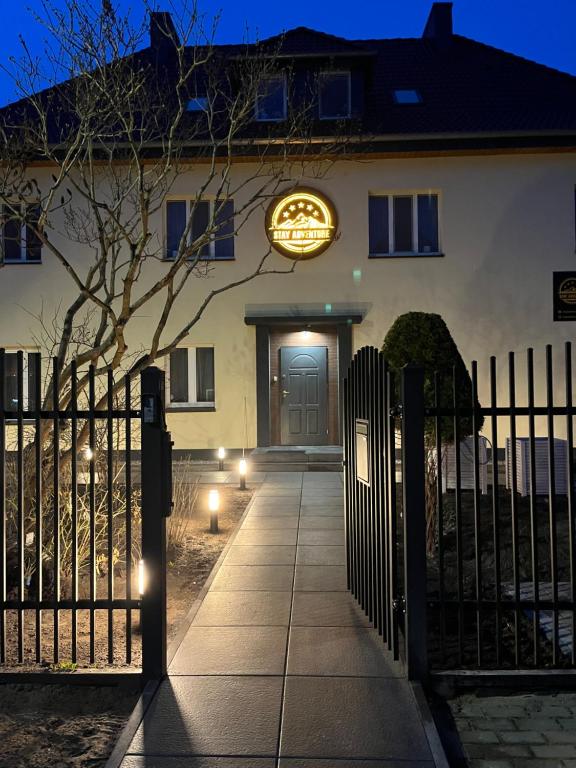 a front door of a house with a sign on it at Stay Adventure Mrzeżyno in Mrzeżyno