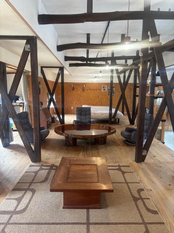 a living room with a couch and a table at 掘っ立て小屋遊々 in Mine