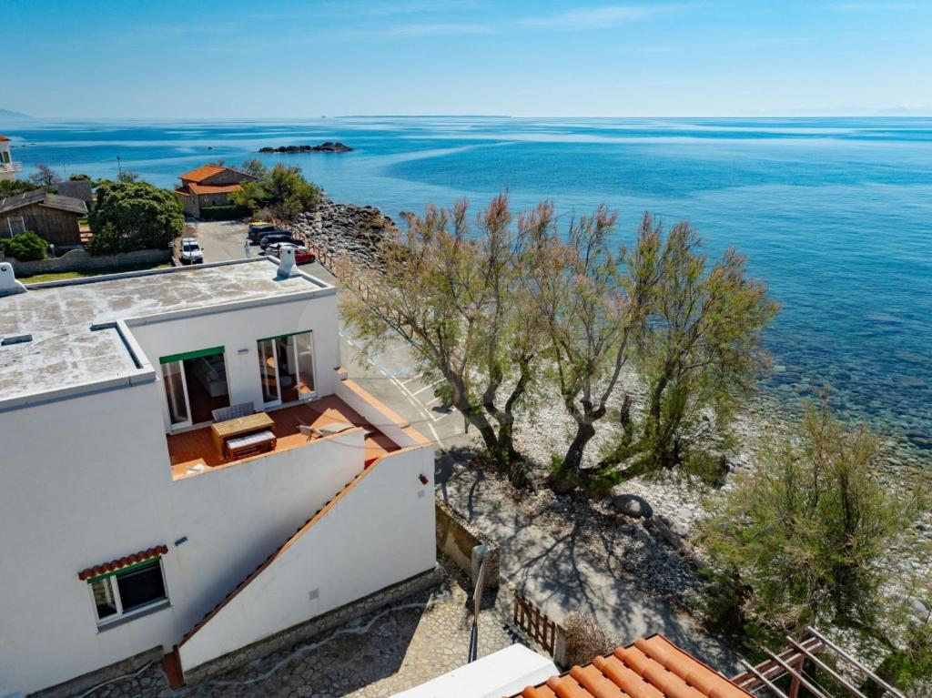 an aerial view of a house and the ocean at Casa Bianca - Goelba in Pomonte