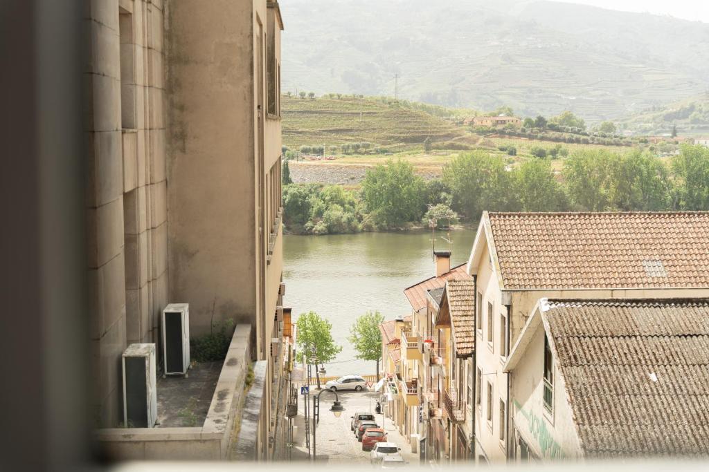 a view of a river from a building at DouroParadise Apartment in Peso da Régua