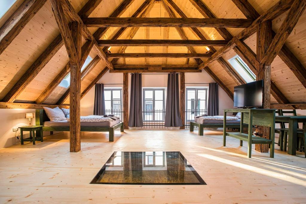 an attic room with two beds and a table at Ubytování V Klenbách in Třeboň
