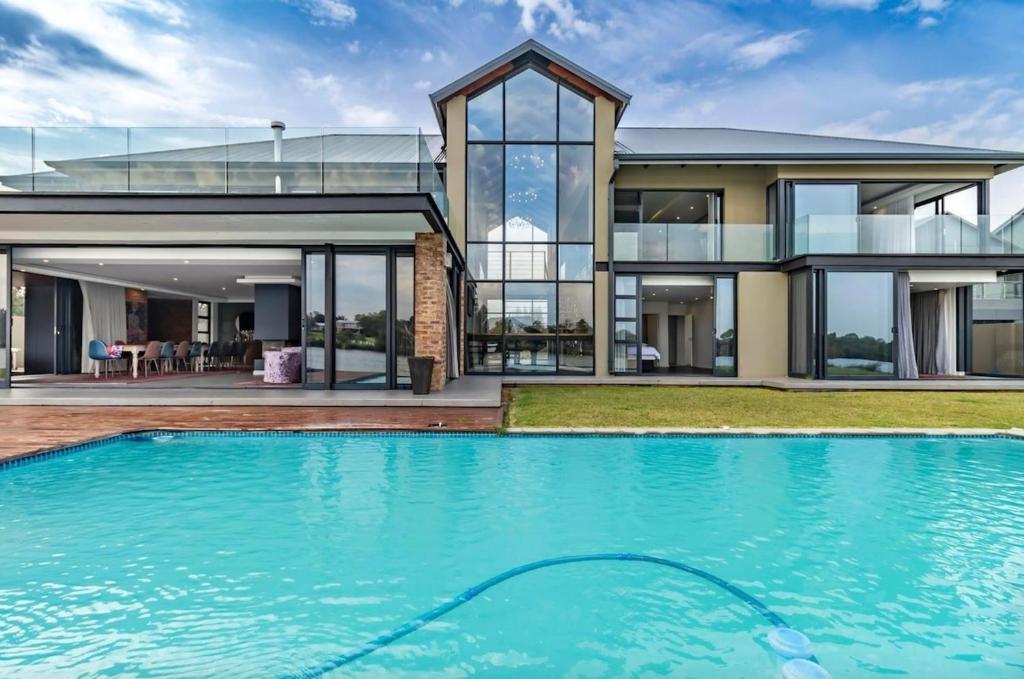 a house with a swimming pool in front of a house at 3066 Water Edge in Parys