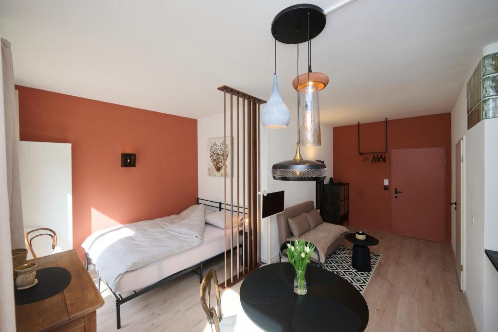 a living room with a bed and a table at AuxMoulins in Neuchâtel