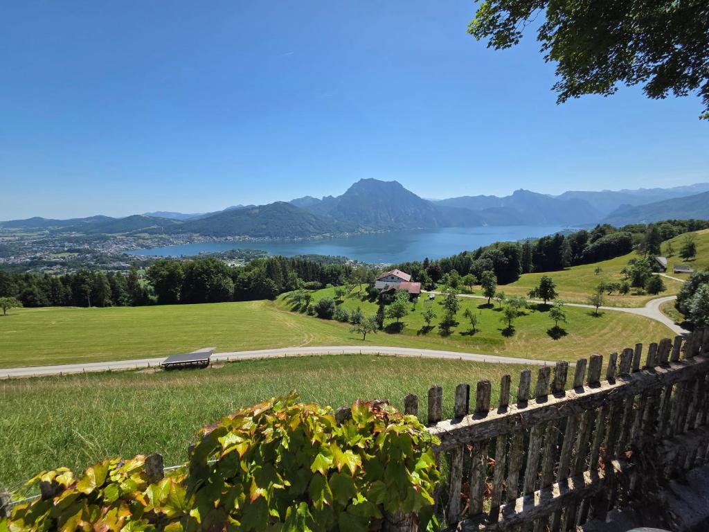 a fence with a view of a lake and mountains at Haus Königsreiter, der besondere Platz in Altmünster