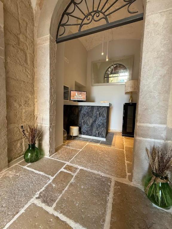 a living room with a fireplace in a building at BeHome in Trani