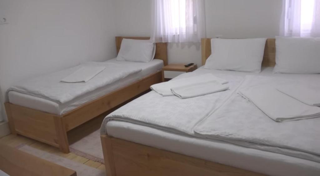 two twin beds in a room with at Hotel Aldi in Rožaje