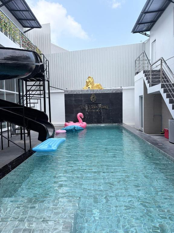 a pool with a water slide in a building at The Lion King Villa in Ban Na