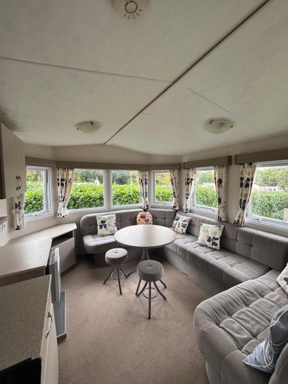 a living room with a couch and a table at Camping le quinquis in Clohars-Carnoët