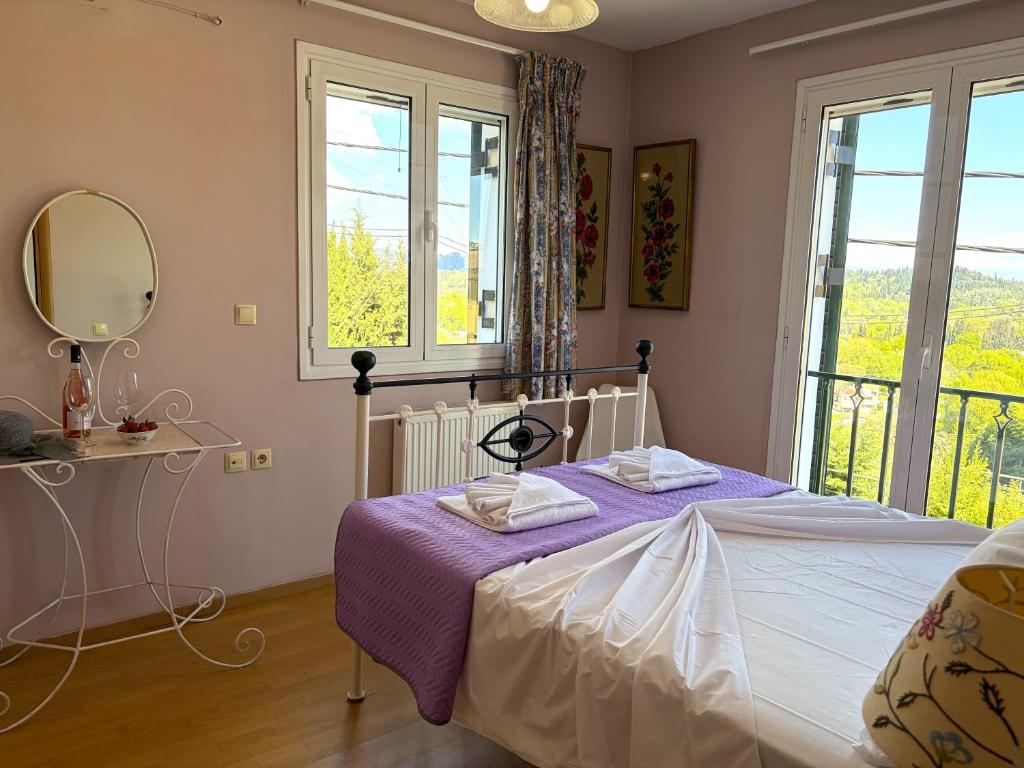 a bedroom with a bed with a mirror and a window at Sunlit Village Escape in Kompítsion