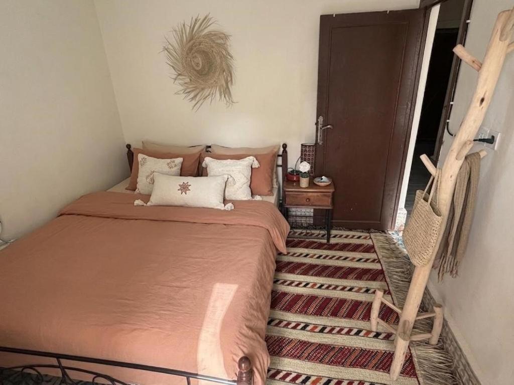 a bedroom with a bed and a chair in it at Studio in City Center Living at Heart of It All, 200 m away from CTM in Er Rachidia