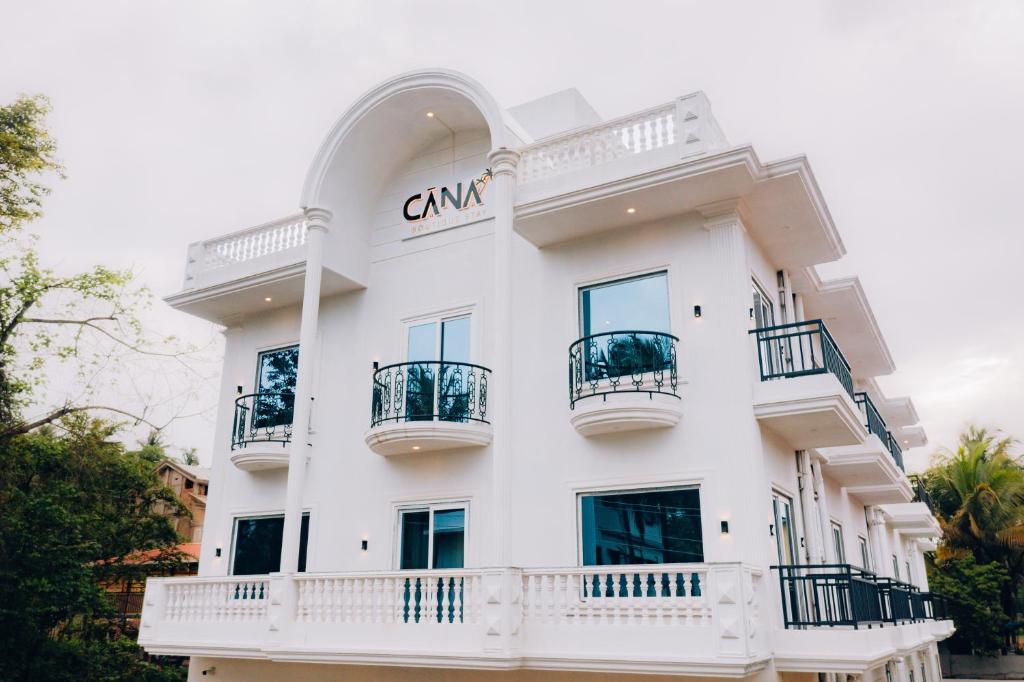 a white building with balconies on it at Cana Boutique Stay in Porvorim