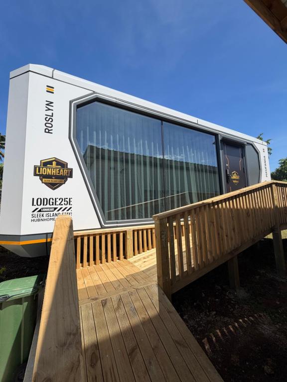 a moving truck parked next to a wooden deck at Lionheart Roslyn Suite 2 in Nuku‘alofa