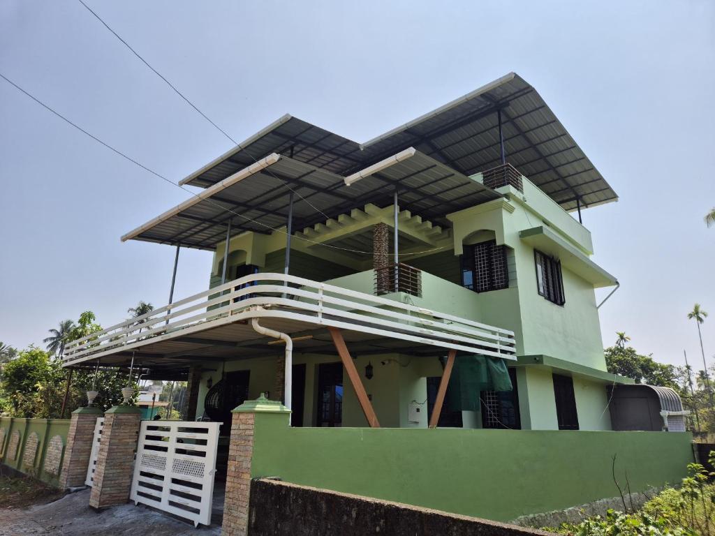 a house with a roof on top of it at meadowell homestay in Kizhake Chālakudi