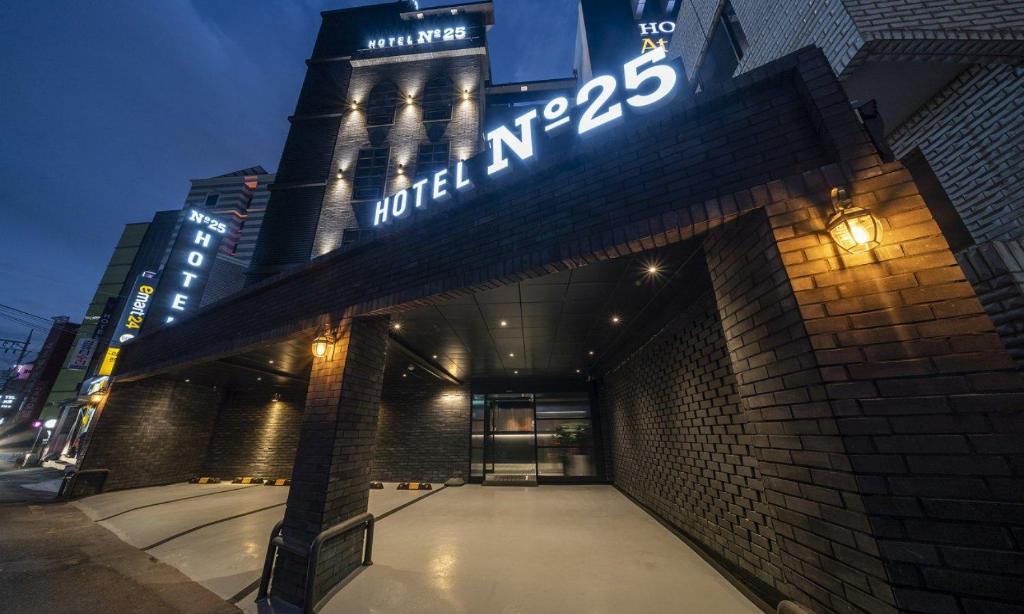 a building with a sign on top of it at 넘버25 신촌점 in Seoul