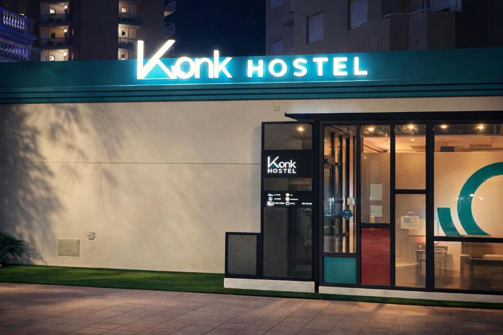 a koxlabel store with a sign on the side of a building at Konk Hostel in La Manga del Mar Menor