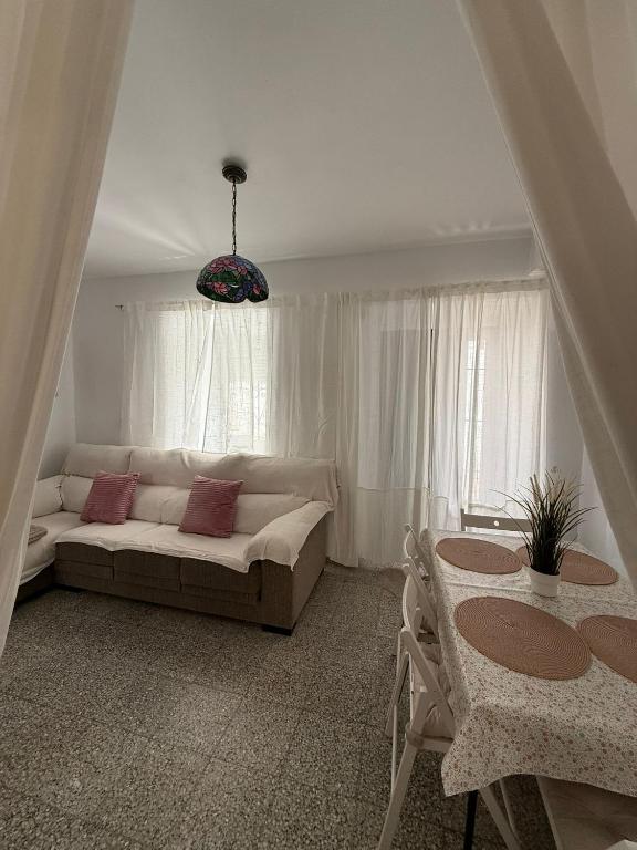 a living room with a couch and a table at Casa de la abuela Tere Caminito del Rey, Valle de Abdalajís, Málaga in Valle de Abdalagís