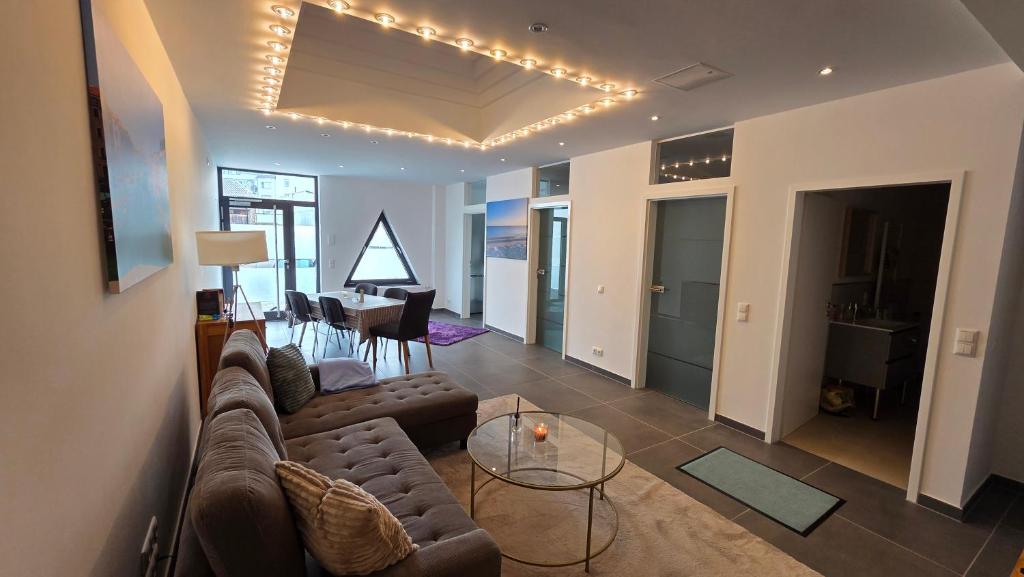 a living room with a couch and a table at Auszeit am Eifeltor in Euskirchen in Euskirchen