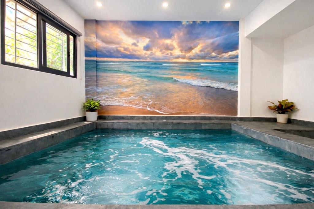 a bathtub with a painting of the ocean at Victoria Villa 2 in Hue