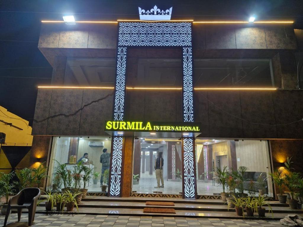 a building with a sign that reads sunilka mehari international at Surmila International Hotel in Āsansol