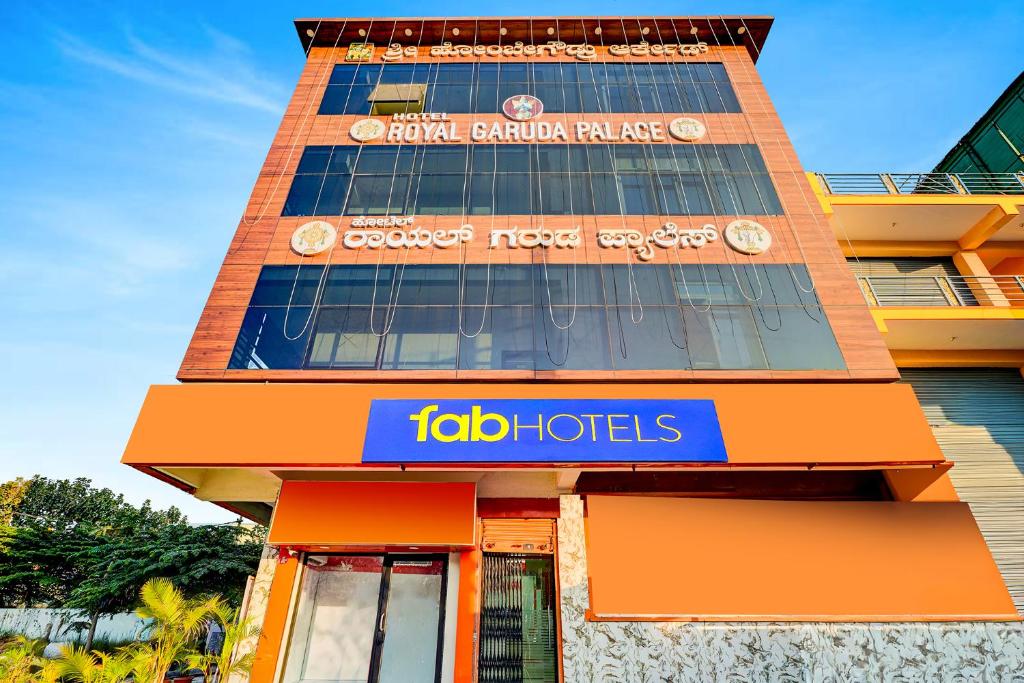 a tall building with a ibid hotel sign on it at FabHotel Royal Garuda Palace in Bangalore