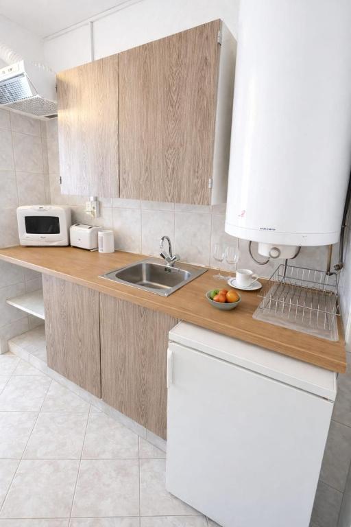 a kitchen with a sink and a microwave at Csopaki promenade in Csopak