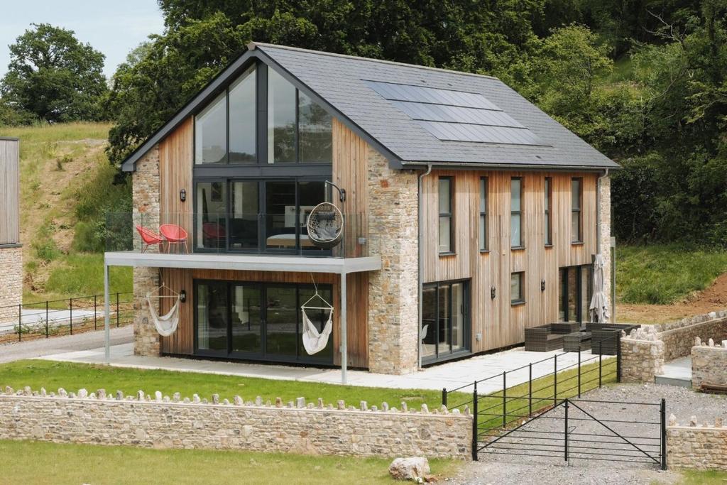 a house with solar panels on top of it at Bluebell Barn - Cookswood in Holcombe