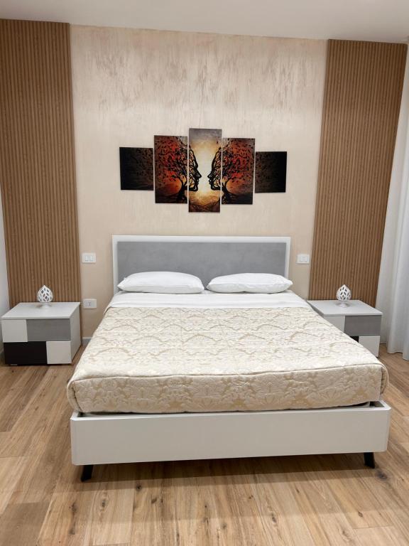 a bedroom with a bed and two night stands at Marra Home B&B in Barletta