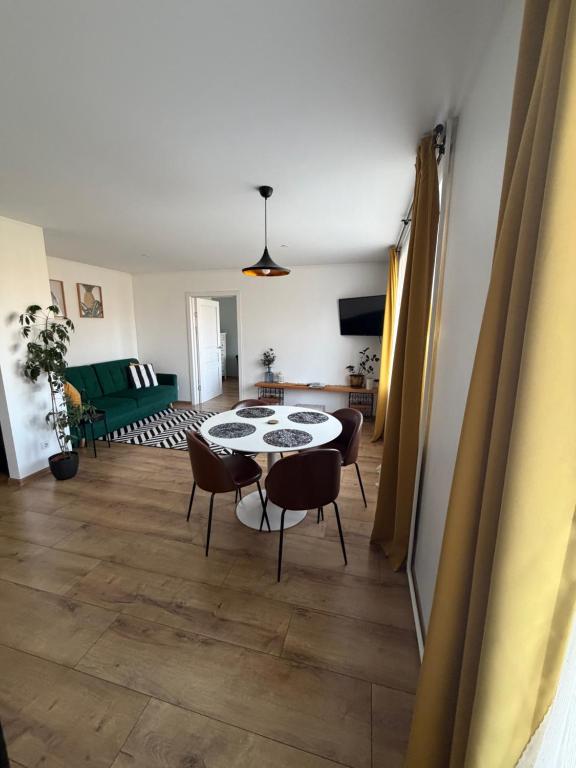 a living room with a table and chairs at Cozy Apartment In Sigulda in Sigulda