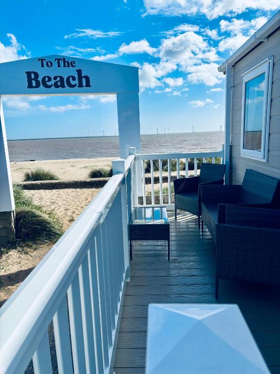 a boardwalk leading to the beach with a beach house at SEA VIEW CARAVAN Disability friendly in Caister-on-Sea