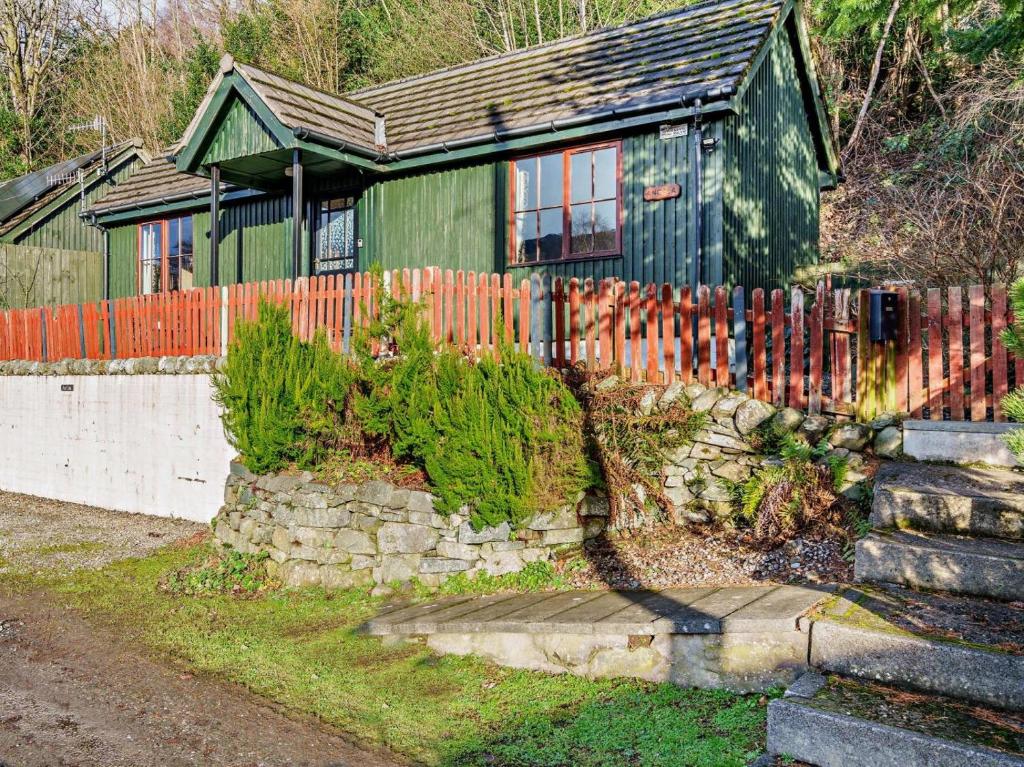 a house with a fence in front of it at 1 Bed in Crieff oc-45288 in Saint Fillans