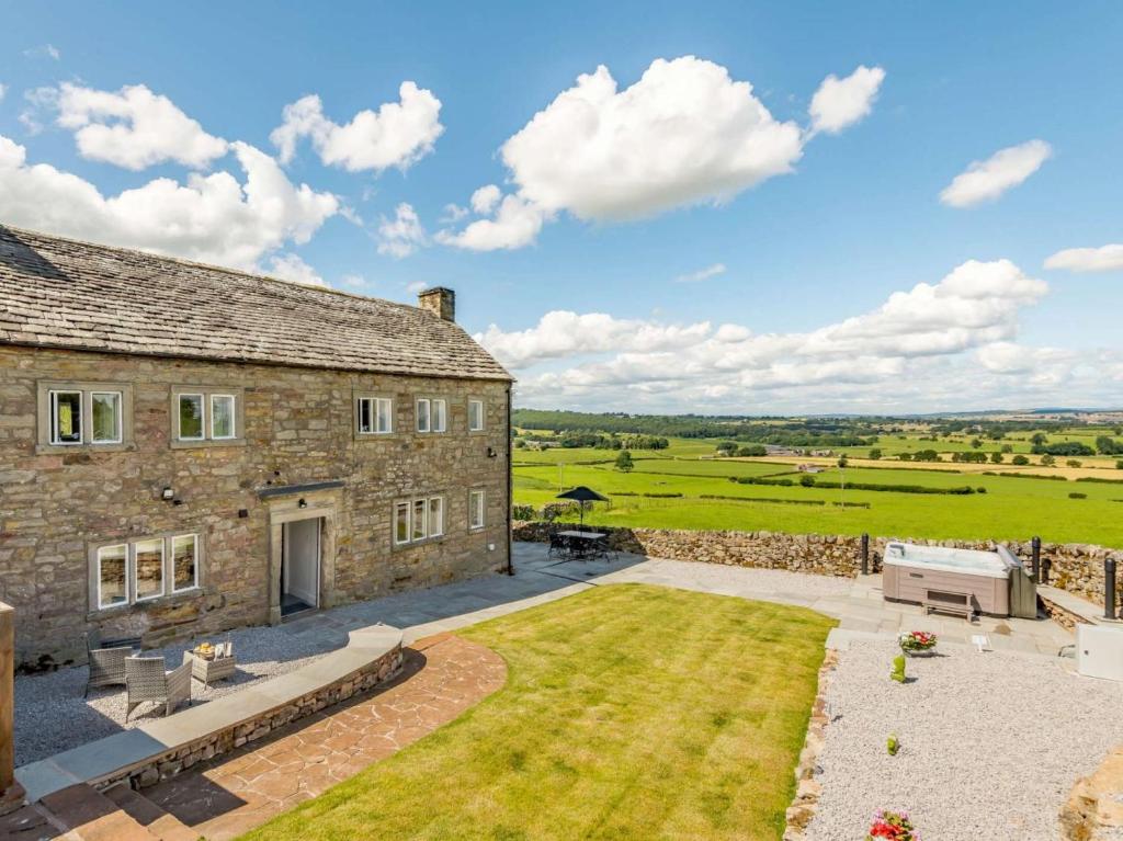 an external view of a stone house with a patio at 3 Bed in Penrith oc-89068 in Tirril