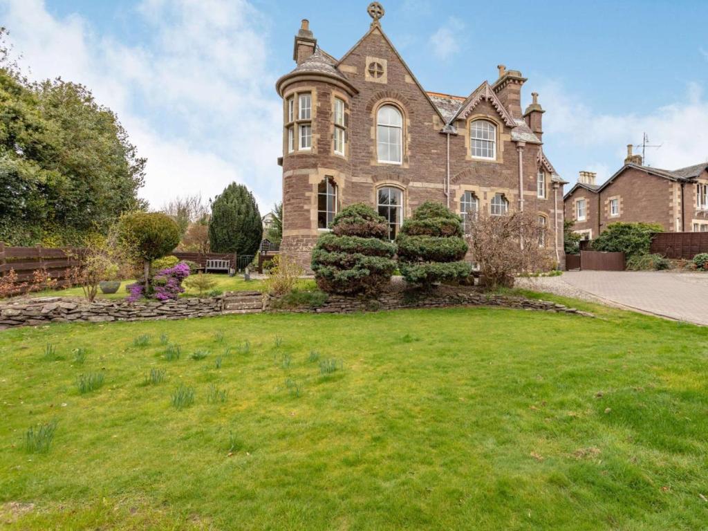 an old house with a grassy yard in front of it at 1 Bed in Crieff oc-87497 in Crieff