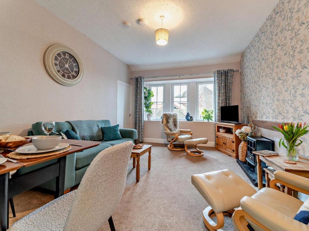 a living room with a couch and a table at 2 Bed in Maybole oc-96012 in Maybole