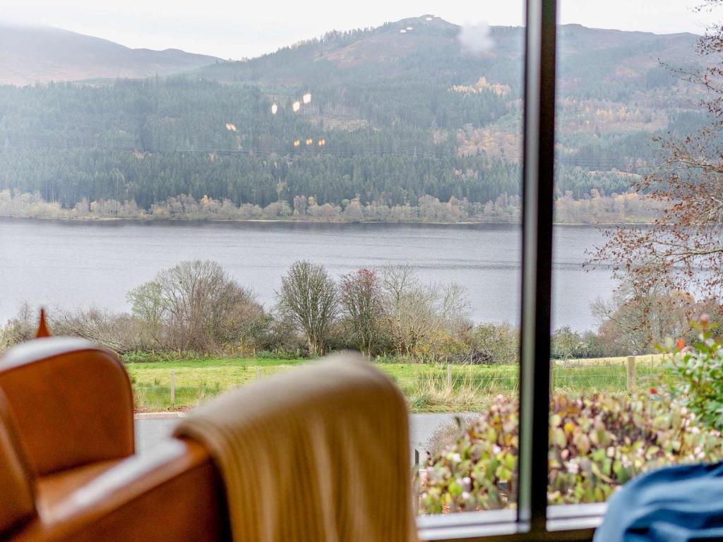 a view of a lake from a room with a window at 3 Bed in Pitlochry oc-ca207 in Struan