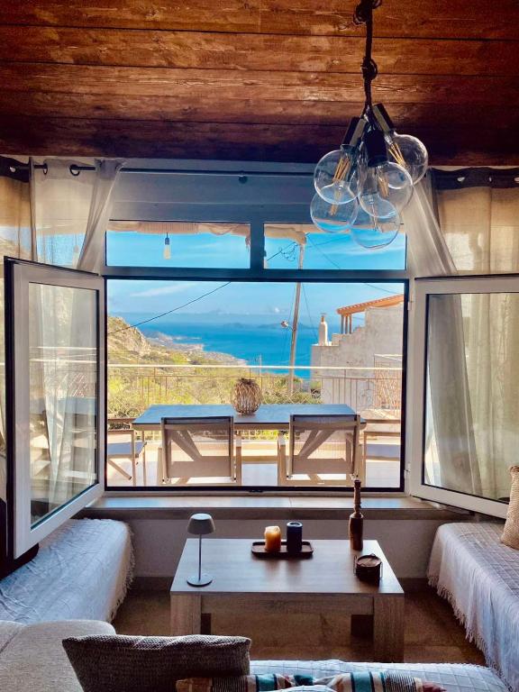 a living room with a large window with a view of the ocean at Harmony Family house in Kerames