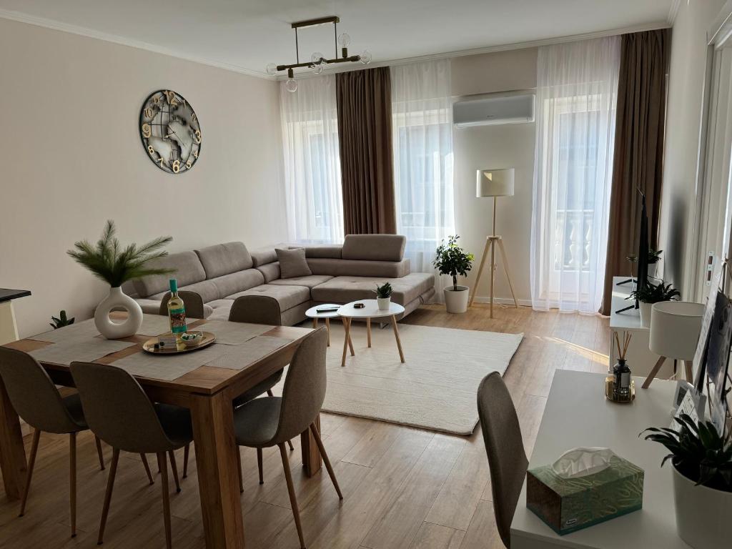 a living room with a table and a couch at Európa Apartman Mini in Békéscsaba