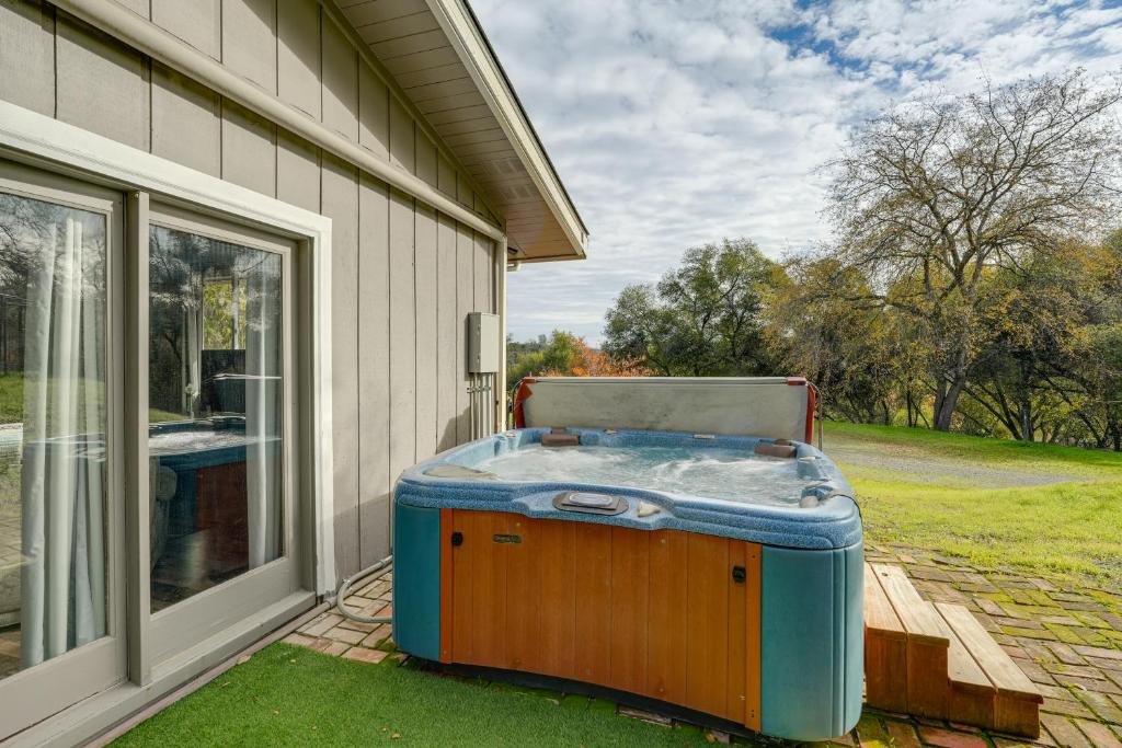 a hot tub sitting on the side of a house at Sweeping Views! Charming Home Near Dtwn Jamestown in Jamestown
