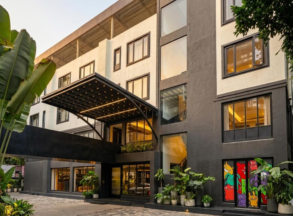 an exterior view of a building with large windows at Wellesley Hotel in Pune