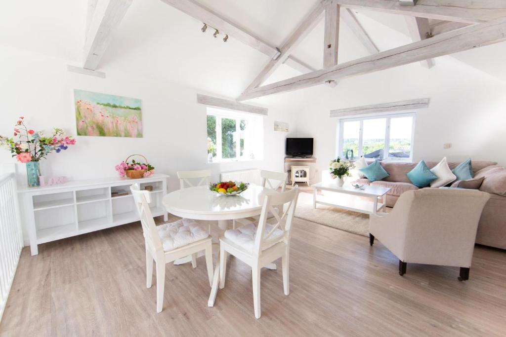 a living room with a table and chairs and a couch at 2 Bed in Upper Vobster oc-c39495 in Mells
