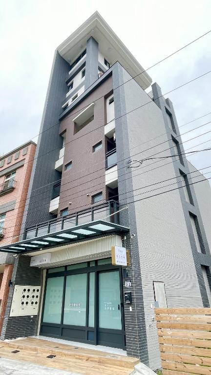 a tall building with glass windows in front of it at Hualien Leo and Alley Elevator B&B in Hualien City