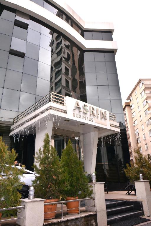 a building with a sign for a sign business at Asrin Business Hotel Kızılay in Ankara