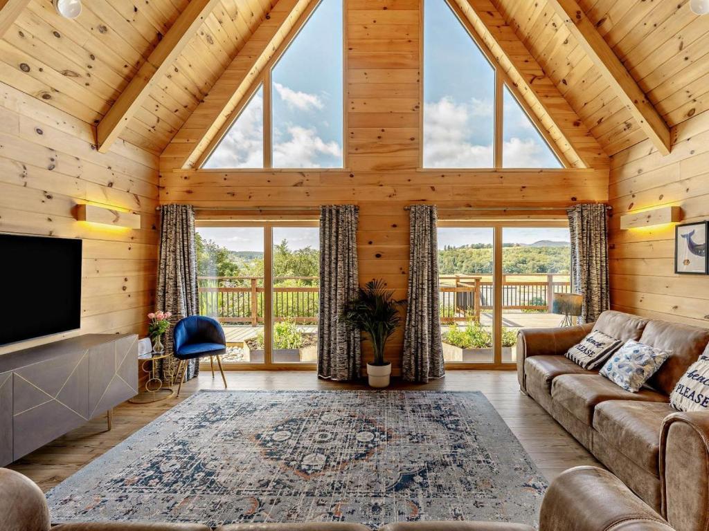 a living room with a couch and a tv at 4 Bed in Kippford oc-95234 in Kippford